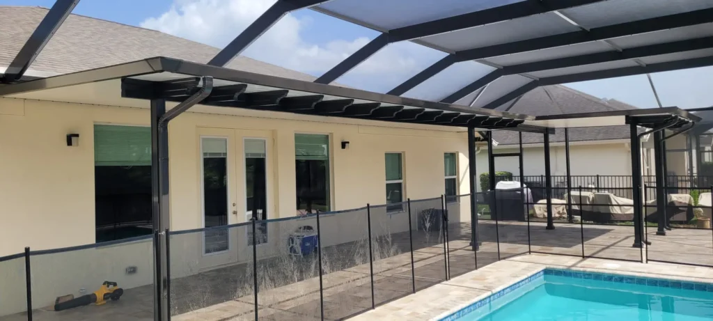 Residential balcony enclosure with white framed windows overlooking an apartment building, installed by All Star Sunrooms.